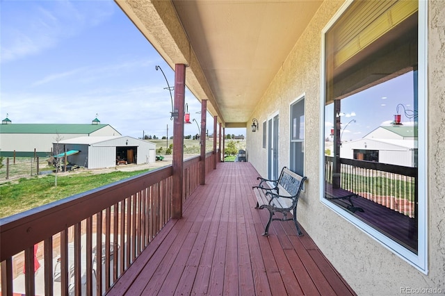 wooden terrace featuring an outbuilding