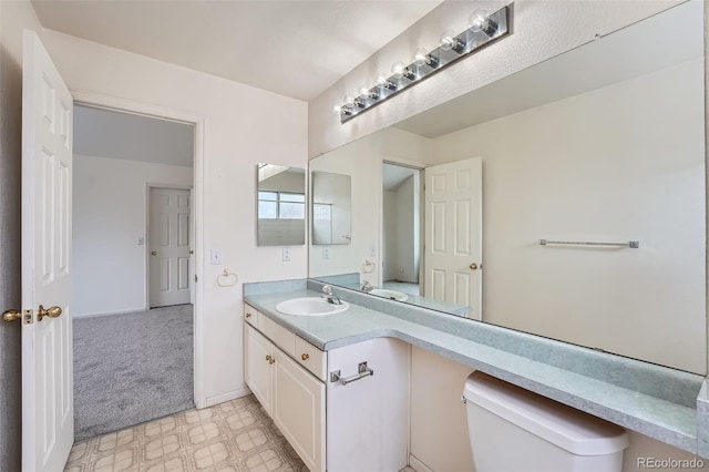 bathroom featuring toilet and vanity