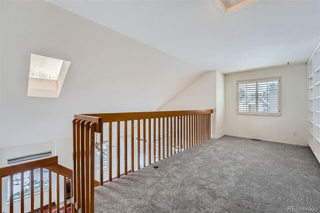 additional living space with carpet and vaulted ceiling with skylight