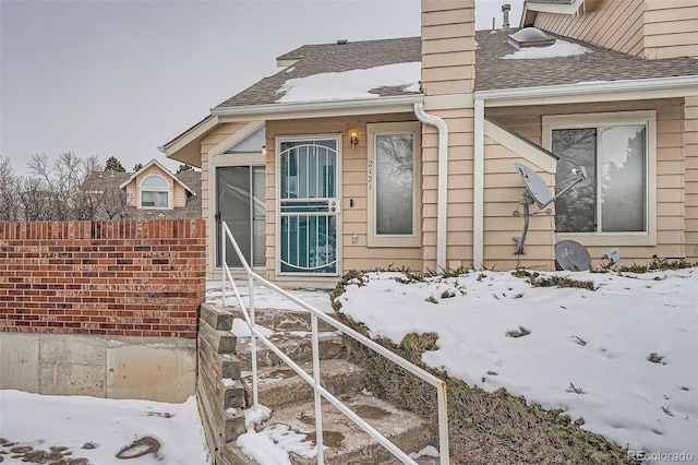 view of snow covered property entrance