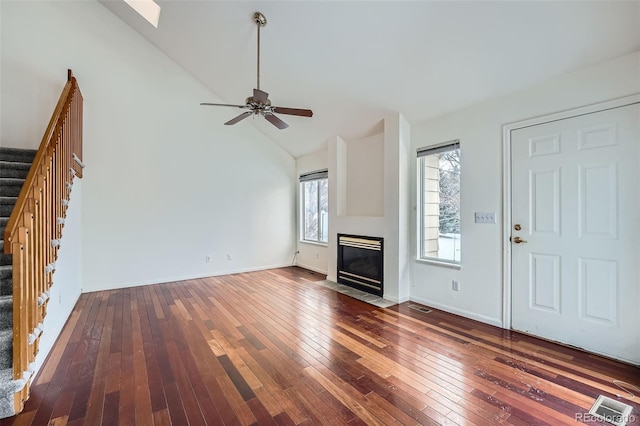 unfurnished living room featuring ceiling fan, dark hardwood / wood-style floors, and lofted ceiling