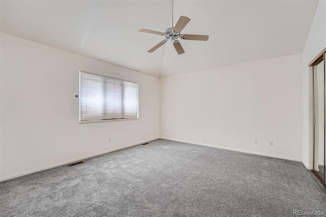 carpeted empty room with ceiling fan and lofted ceiling