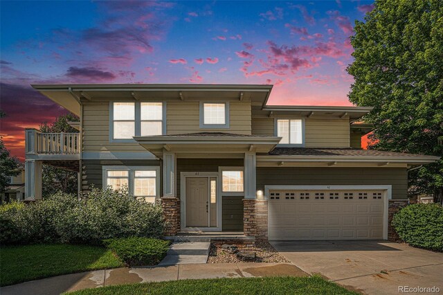 3000 E 112th Ave Unit 61, Northglenn, CO 80233 - view of front of house featuring an attached garage, concrete driveway, and stone siding