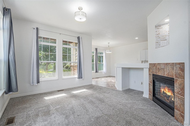3000 E 112th Ave Unit 61, Northglenn, CO 80233 - unfurnished living room with carpet, a tile fireplace, a chandelier, and recessed lighting