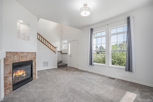 3000 E 112th Ave Unit 61, Northglenn, CO 80233 - entryway featuring carpet, stairway, and a tiled fireplace
