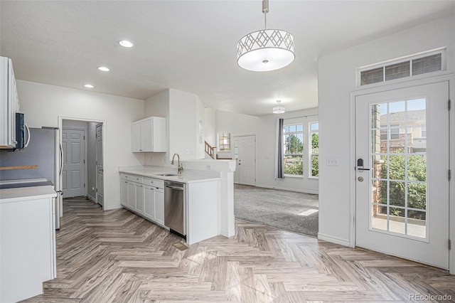 3000 E 112th Ave Unit 61, Northglenn, CO 80233 - kitchen featuring stainless steel dishwasher, recessed lighting, light countertops, white cabinetry, and open floor plan