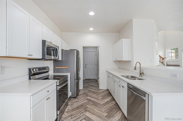 3000 E 112th Ave Unit 61, Northglenn, CO 80233 - kitchen with stainless steel appliances, recessed lighting, white cabinetry, and light countertops