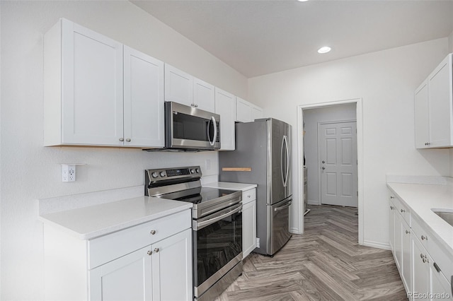 3000 E 112th Ave Unit 61, Northglenn, CO 80233 - kitchen featuring stainless steel appliances, recessed lighting, light countertops, and white cabinetry