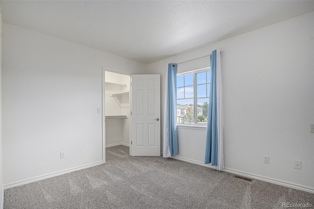 3000 E 112th Ave Unit 61, Northglenn, CO 80233 - unfurnished bedroom featuring carpet and a walk in closet