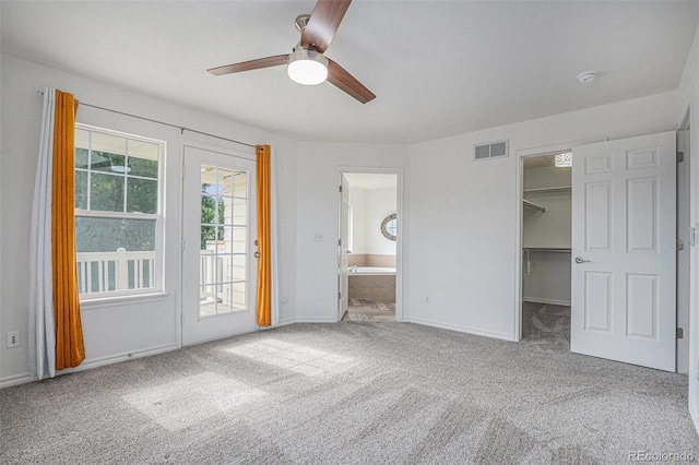 3000 E 112th Ave Unit 61, Northglenn, CO 80233 - unfurnished bedroom featuring carpet, access to exterior, a walk in closet, ensuite bath, and ceiling fan