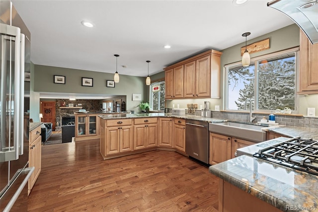 2857 Hiwan Dr, Evergreen, CO 80439 - kitchen featuring a peninsula, appliances with stainless steel finishes, a sink, and a wealth of natural light