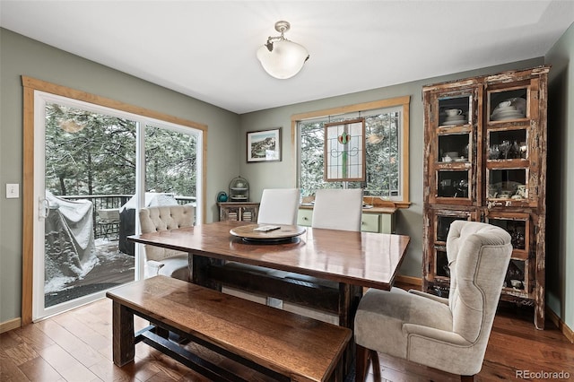 2857 Hiwan Dr, Evergreen, CO 80439 - dining room with baseboards, wood finished floors, and a healthy amount of sunlight