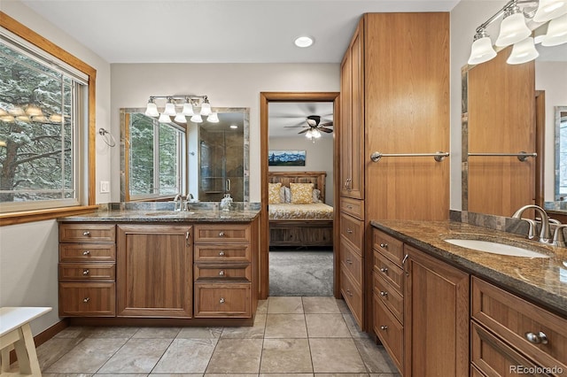 2857 Hiwan Dr, Evergreen, CO 80439 - ensuite bathroom featuring a shower with shower door, two vanities, ensuite bathroom, and a sink