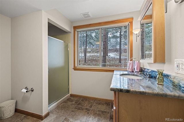 2857 Hiwan Dr, Evergreen, CO 80439 - bathroom featuring a healthy amount of sunlight, vanity, baseboards, and visible vents