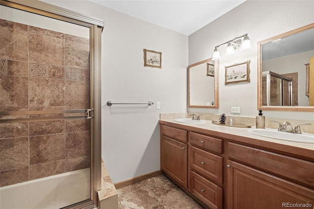 2857 Hiwan Dr, Evergreen, CO 80439 - full bath with a sink, baseboards, double vanity, and a shower with door
