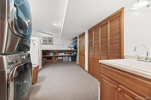 2857 Hiwan Dr, Evergreen, CO 80439 - laundry room with stacked washer / drying machine, a sink, and carpet floors