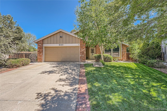 8164 Flower Cir, Arvada, CO 80005 - mid-century modern home featuring a garage, driveway, brick siding, and board and batten siding