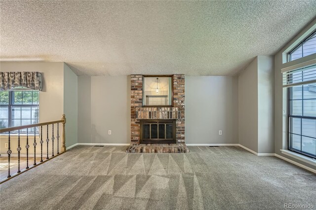 8164 Flower Cir, Arvada, CO 80005 - unfurnished living room featuring a textured ceiling, plenty of natural light, carpet floors, and a fireplace