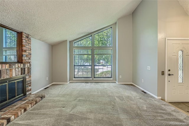8164 Flower Cir, Arvada, CO 80005 - unfurnished living room featuring lofted ceiling, a textured ceiling, carpet, a fireplace, and baseboards