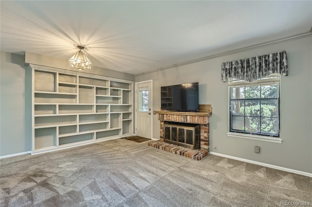 8164 Flower Cir, Arvada, CO 80005 - unfurnished living room featuring a chandelier, carpet, a brick fireplace, baseboards, and crown molding