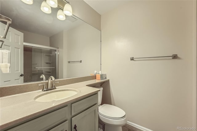 8164 Flower Cir, Arvada, CO 80005 - full bathroom with vanity, a stall shower, toilet, and baseboards