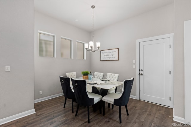 dining room with a notable chandelier and dark hardwood / wood-style flooring