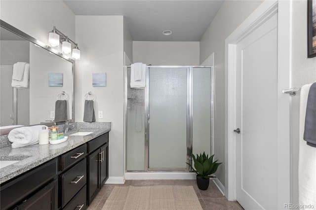 bathroom featuring vanity, tile patterned floors, and a shower with shower door