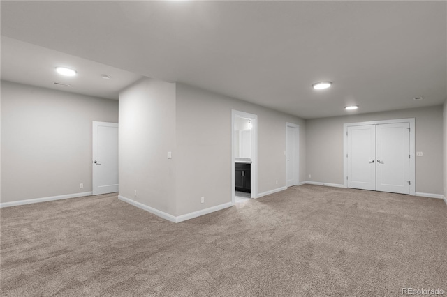 basement featuring light colored carpet