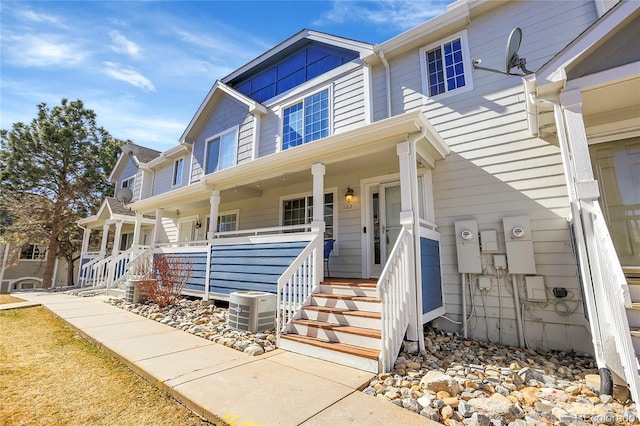 multi unit property featuring a porch and central AC unit