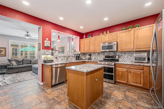 860 Bristle Pine Cir Unit A, Highlands Ranch, CO 80129 - kitchen featuring stainless steel appliances, tasteful backsplash, a kitchen island, recessed lighting, and open floor plan