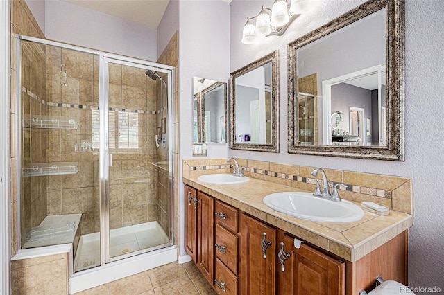 860 Bristle Pine Cir Unit A, Highlands Ranch, CO 80129 - bathroom featuring a shower stall, double vanity, tile patterned flooring, decorative backsplash, and a textured wall