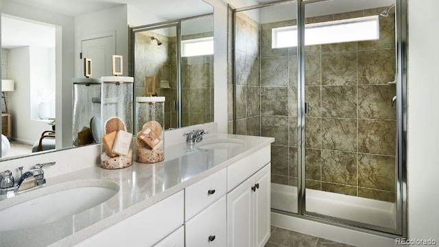 bathroom featuring walk in shower, vanity, and tile patterned floors