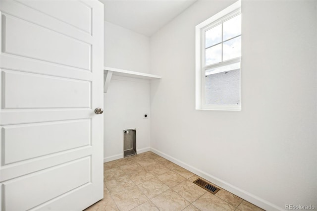 laundry room featuring laundry area, visible vents, electric dryer hookup, and baseboards