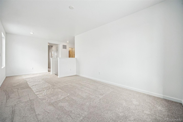 unfurnished room featuring recessed lighting, visible vents, light carpet, and baseboards