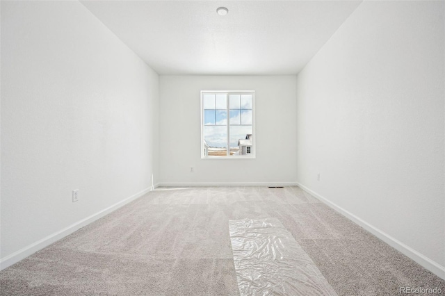 empty room with light carpet and baseboards