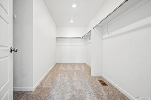 walk in closet featuring carpet floors and visible vents