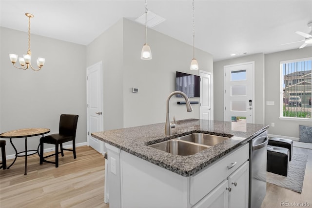 19629 W 93rd Dr Unit C, Arvada, CO 80007 - kitchen with light wood-style floors, stainless steel dishwasher, white cabinetry, a chandelier, and pendant lighting