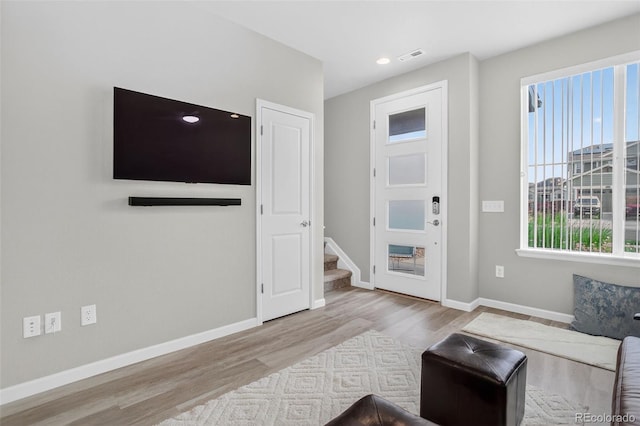 19629 W 93rd Dr Unit C, Arvada, CO 80007 - unfurnished living room featuring wood finished floors, stairway, plenty of natural light, and recessed lighting