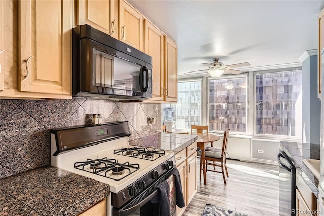 kitchen with light brown cabinetry, decorative backsplash, black microwave, range with gas cooktop, and light wood-type flooring