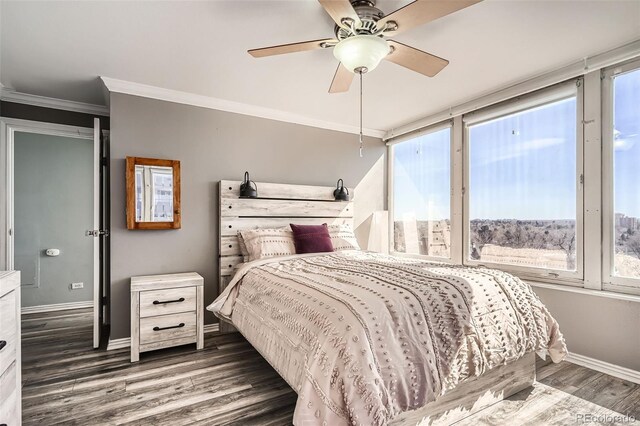 bedroom with ceiling fan, baseboards, wood finished floors, and crown molding