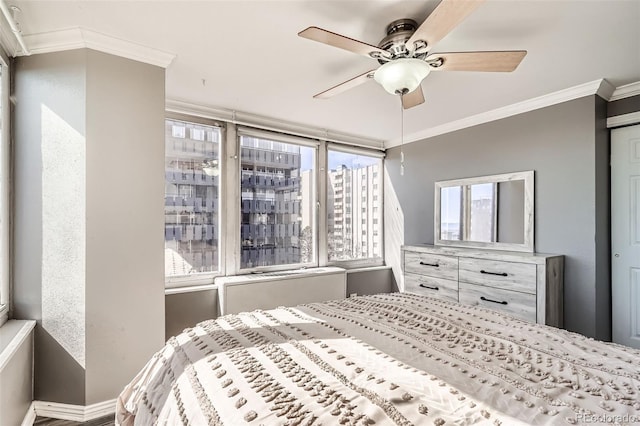 bedroom with ceiling fan, a view of city, and ornamental molding