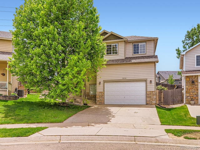 view of front facade featuring an attached garage, stone siding, and driveway