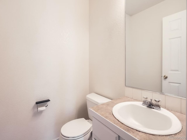 half bathroom with toilet and vanity
