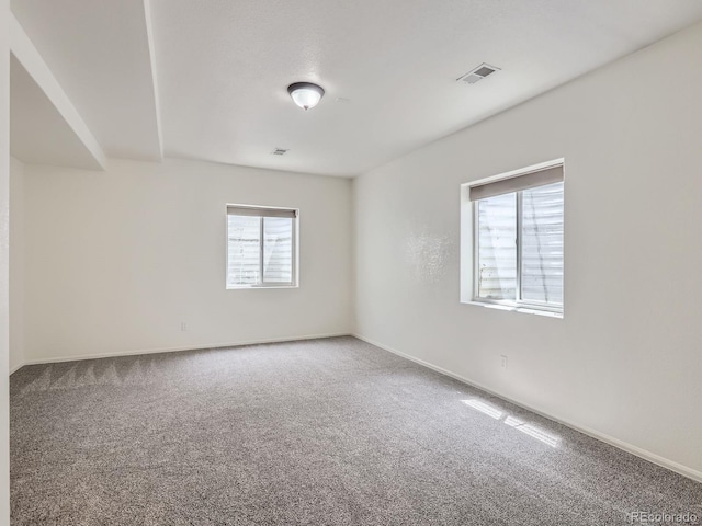 carpeted spare room with baseboards