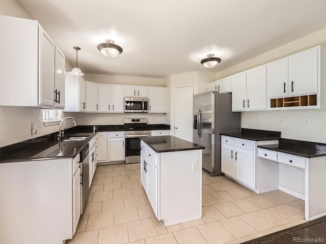 8614 19th St, Greeley, CO 80634 - kitchen featuring stainless steel appliances, a sink, white cabinets, and a center island