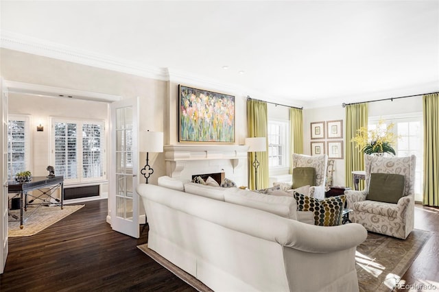 living room with plenty of natural light, dark hardwood / wood-style floors, and ornamental molding