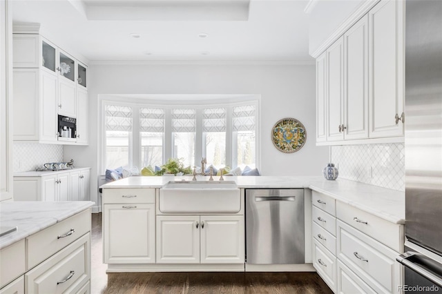 kitchen with white cabinetry, stainless steel appliances, and tasteful backsplash