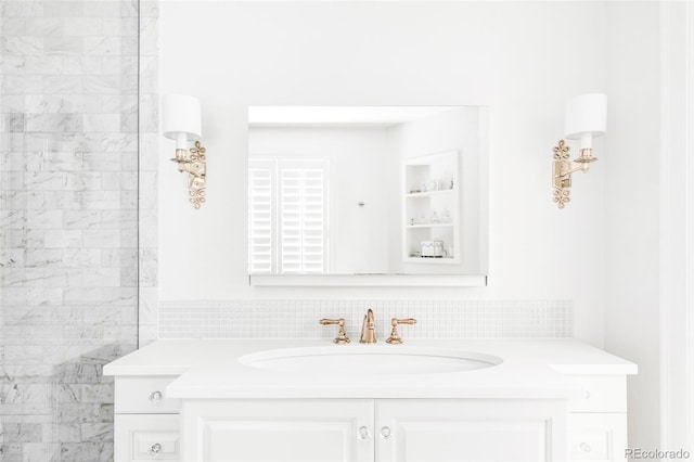 bathroom with built in shelves and vanity