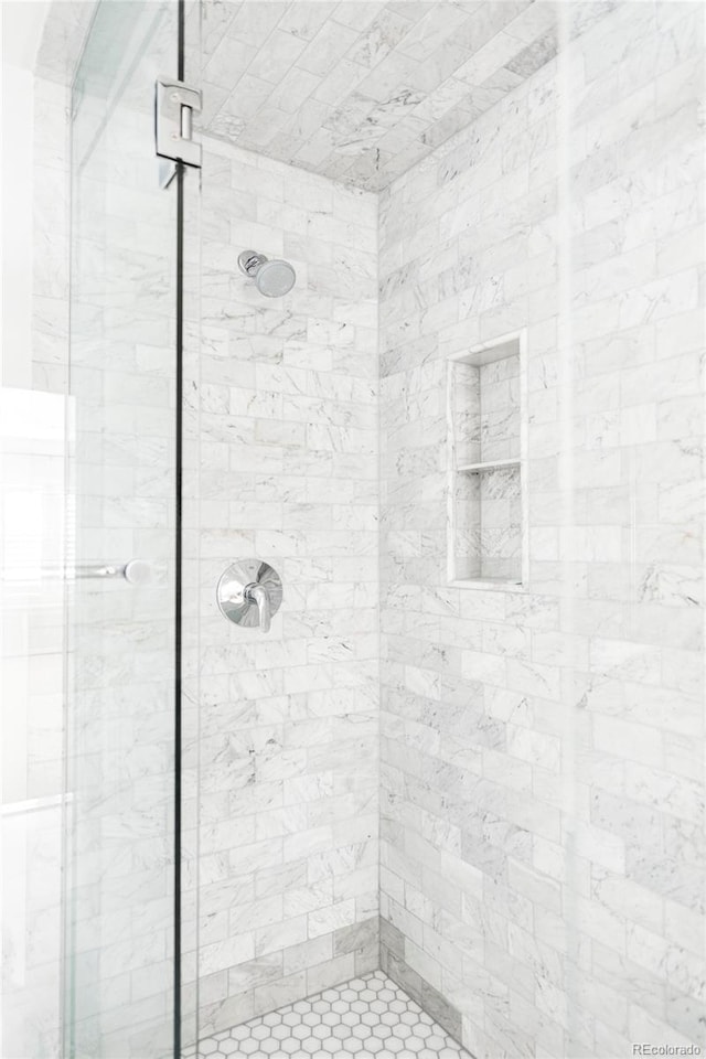 bathroom with a shower with door