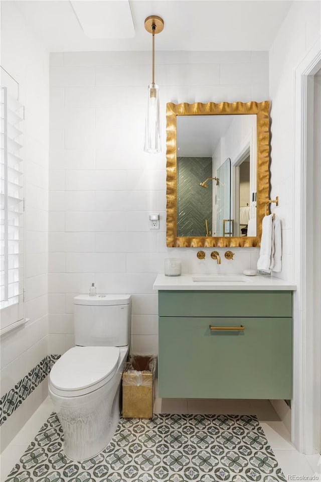 bathroom with vanity, toilet, and tile patterned floors